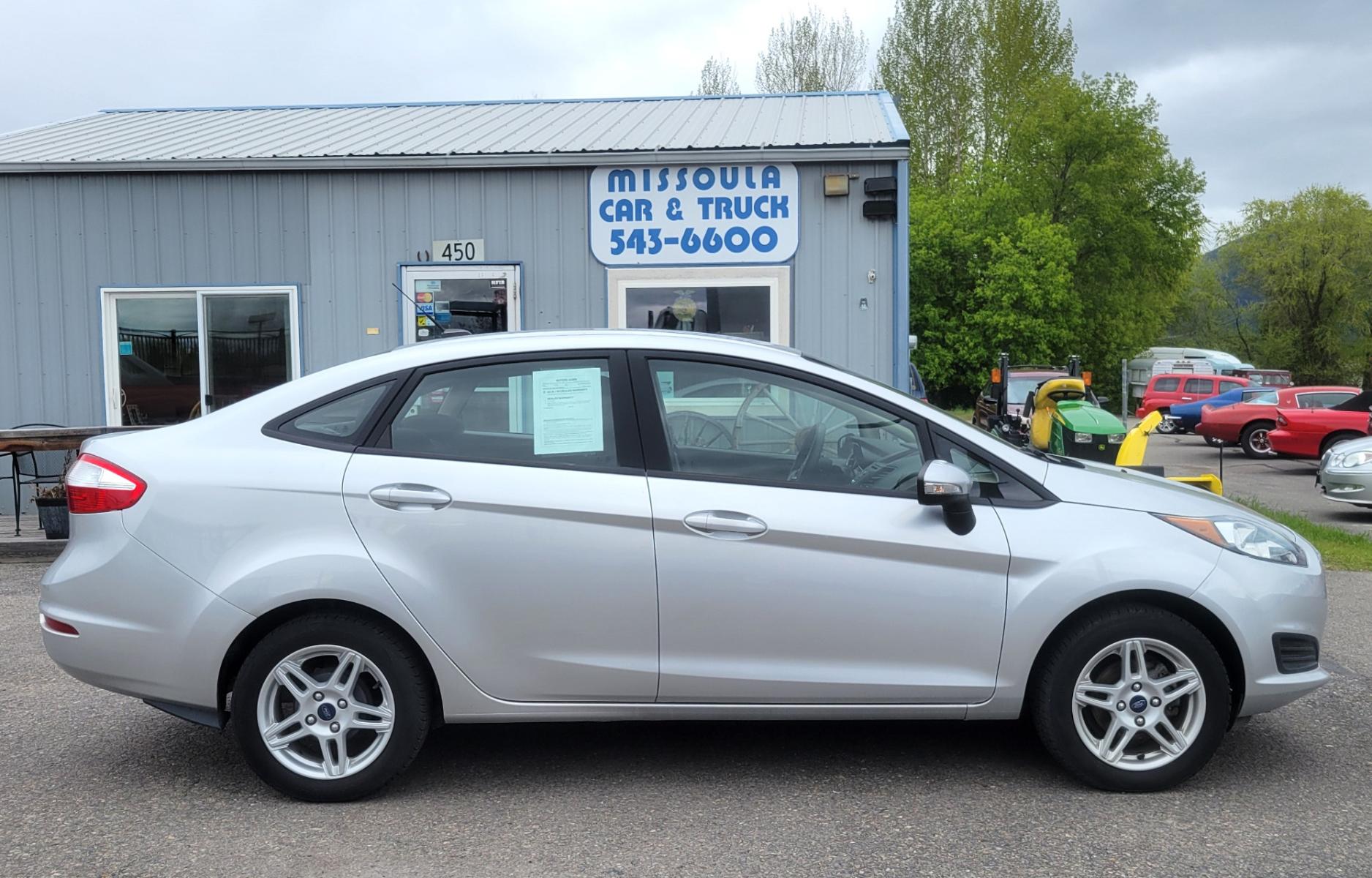 2019 Silver Ford Fiesta SE Sedan (3FADP4BJ2KM) with an 1.6L L4 DOHC 16V engine, Automatic transmission, located at 450 N Russell, Missoula, MT, 59801, (406) 543-6600, 46.874496, -114.017433 - Great little Economy Car in Very Good Condition. Low Miles. Automatic Transmission. Air Conditioning. Heated Seats. Power Windows. Cruise. Tilt. Backup Camera. - Photo #0